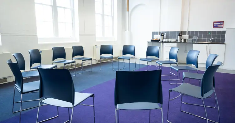 Living room circle of chairs with kitchen