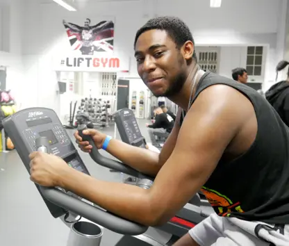 Man exercising on cycling machine in Lift Gym